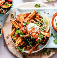 Sweet potato fries with toppings and sour cream.